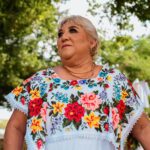 Senior woman wearing floral blouse in Tulum, Mexico outdoors.